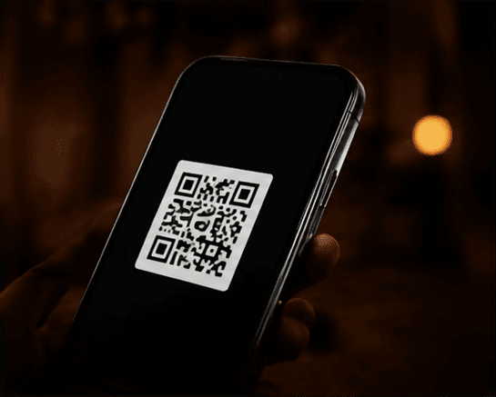 A phone displaying a QR code for a scan-to-save moment